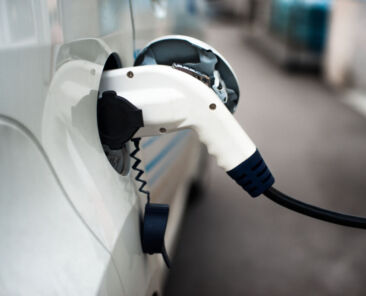 Charging,An,Electric,Car,With,The,Power,Cable,Supply,Plugged