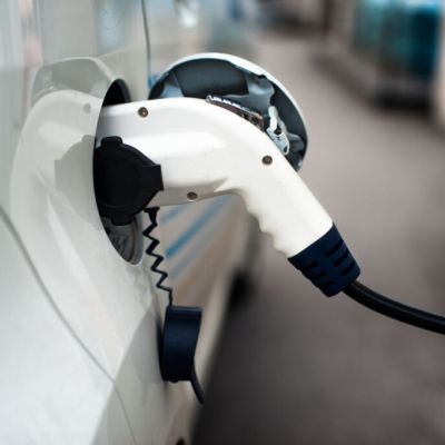 Charging,An,Electric,Car,With,The,Power,Cable,Supply,Plugged